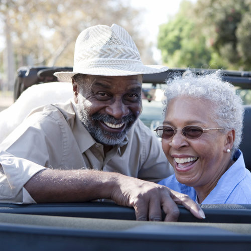 Older Couple Riding In A Convertible